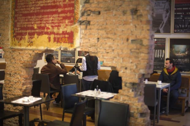 Patrons sip coffee at a cafe in Beijing's Arts district